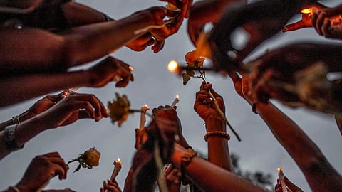 Congolese civilians hold candles to pay tribute to victims killed by rains that ripped through the riverside villages of Nyamukubi and Bushushu, in South Kivu province, during a vigil in Goma, Democratic Republic of Congo, May 9, 2023. 