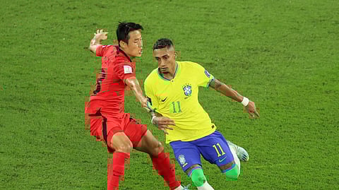 FILE PHOTO: Soccer Football - FIFA World Cup Qatar 2022 - Round of 16 - Brazil v South Korea - Stadium 974, Doha, Qatar - December 5, 2022 Brazil's Raphinha in action with South Korea's Son Jun-ho 