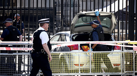 Police officers work at the site where a car crashed into the front gates of Downing Street in London, Britain, May 25, 2023. 