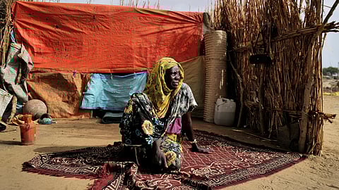 FILE PHOTO: Halime Adam Moussa, a Sudanese refugee who is seeking refuge in Chad for a second time, sits beside her shelter, near the border between Sudan and Chad in Koufroun, Chad, May 10, 2023. 