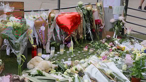 Flowers, candles and messages left to pay tribute to the victims are seen at the children's playground the day after several children and adults were injured in a knife attack at the Le Paquier park near the lake in Annecy, in the French Alps, France, June 9, 2023. 