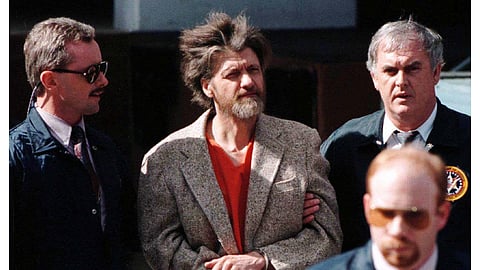 FILE PHOTO: Theodore Kaczynski is led out of federal court where he was charged with a single federal weapons violation April 4,1997.