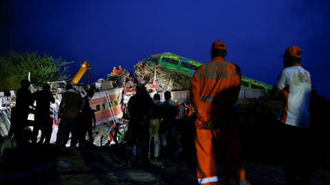 Heavy machinery operates as rescue workers search for survivors at the site of a train collision after the accident in Balasore district in the eastern state of Odisha, India, June 3, 2023.