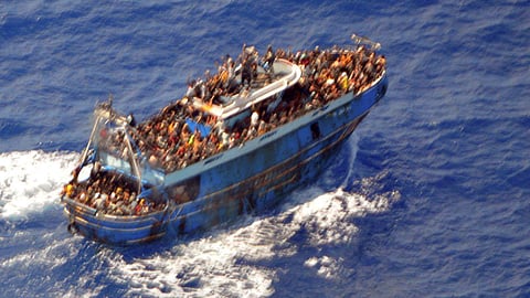 FILE PHOTO: A undated handout photo provided by the Hellenic Coast Guard shows migrants onboard a boat during a rescue operation, before their boat capsized on the open sea, off Greece, June 14, 2023. 