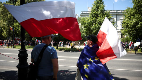 People wait for a march organised by main opposition party the Civic Platform (PO) on the 34th anniversary of the first democratic elections in postwar Poland, in Warsaw, Poland, June 4, 2023. 
