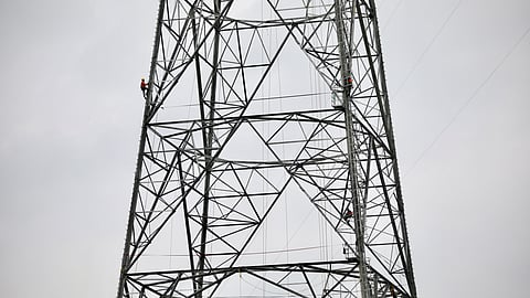 FILE PHOTO: A worker climbs an under construction power transmission tower in Munshiganj, outskirts of Dhaka, Bangladesh, June 30, 2021. 