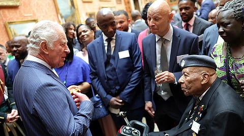 Britain's King Charles III speaks with a guest during a reception to mark the 75th anniversary of the arrival of HMT Empire Windrush, at Buckingham Palace, London, Britain, on June 14, 2023. 