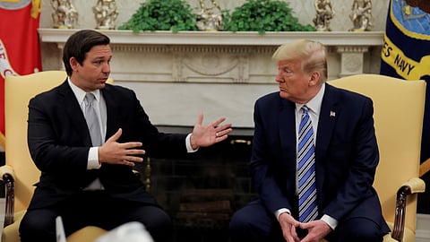 FILE PHOTO: U.S. President Donald Trump listens to Florida Governor Ron DeSantis speak about the coronavirus response during a meeting in the Oval Office at the White House in Washington, U.S., April 28, 2020. 