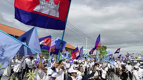 FILE PHOTO: Supporters of the opposition party, Candlelight Party, wave flags as they take part in a campaign rally for the upcoming local elections on June 5, in Phnom Penh, Cambodia May 21, 2022. Picture taken May 21, 2022. 