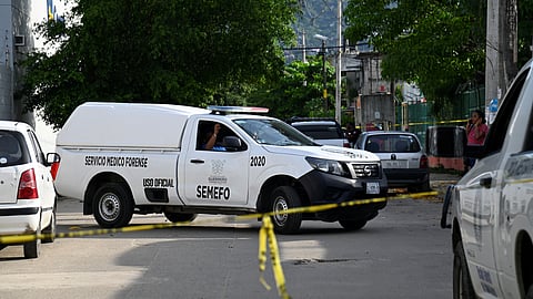 A general view of a Forensic Medical Service vehicle behind barricade tape at the crime scene, following the death of Mexican journalist Nelson Matus, in Acapulco, Mexico July 15, 2023 in this handout image. 