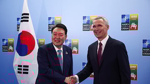 FILE PHOTO: NATO Secretary-General Jens Stoltenberg shakes hands with South Korea's President Yoon Suk Yeol on the day of a NATO leaders summit in Vilnius, Lithuania July 11, 2023. 