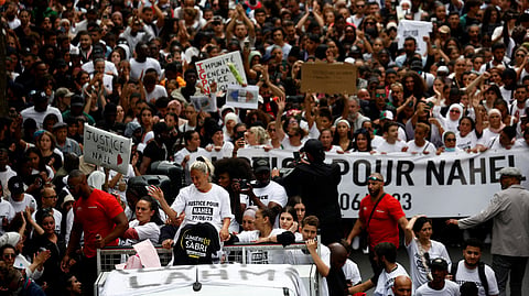 Mounia, the mother of Nahel, a 17-year-old teenager killed by a French police officer in Nanterre during a traffic stop, and relatives stand on a van as they attend a march in tribute to Nahel in Nanterre, Paris suburb, France, June 29, 2023. 
