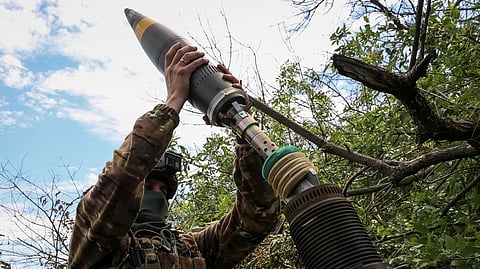 FILE PHOTO: A Ukrainian serviceman, of the 10th separate mountain assault brigade of the Armed Forces of Ukraine, prepares to fire a mortar at their positions at a front line, amid Russia's attack on Ukraine, near the city of Bakhmut in Donetsk region, Ukraine July 13, 2023. 