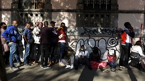 Migrants wait in line to regularize their migratory situation outside Mexico's Commission for Refugee Assistance (COMAR) in Mexico City Mexico, January 20, 2023. 