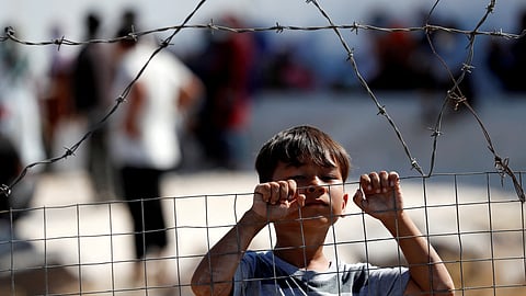 FILE PHOTO: A child is seen at the new temporary camp for migrants and refugees, on the island of Lesbos, Greece, September 23, 2020. 