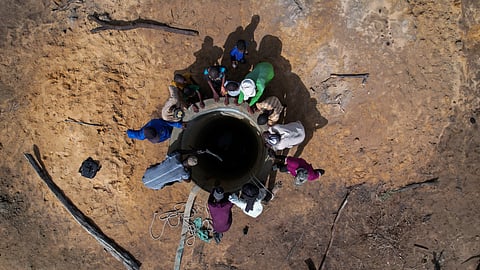 Workers and villagers gather around a well, being built with the help of crowdfunding, in Ourou Amady Bagga, Podor region, Senegal July 8, 2023.