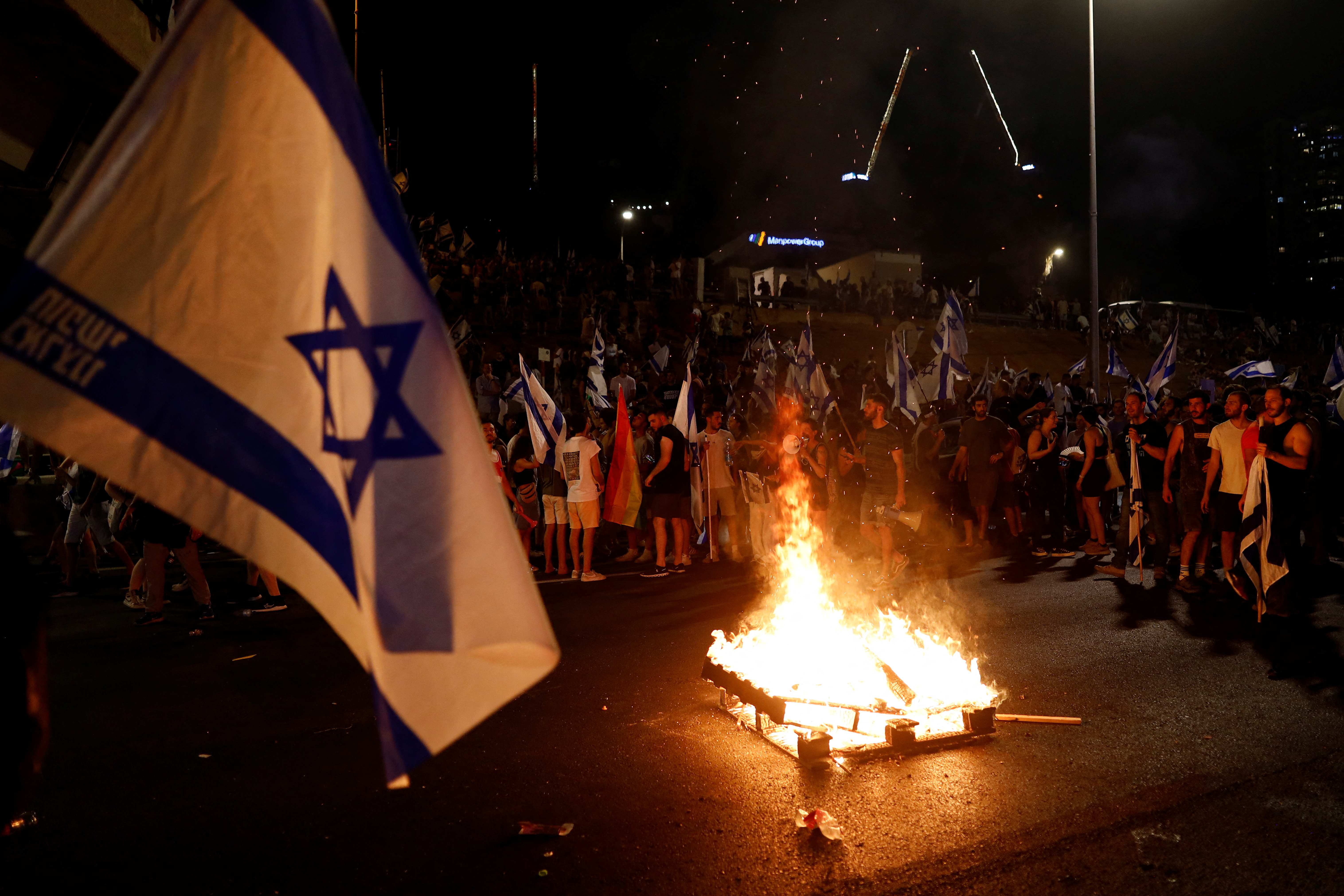 FILE PHOTO: Protesters block Ayalon Highway during a demonstration following a parliament vote on a contested bill that limits Supreme Court powers to void some government decisions, in Tel Aviv, Israel July 24, 2023. 