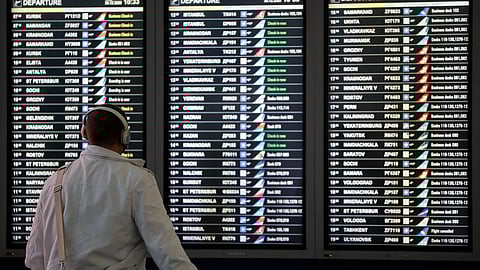 A man looks at a flight information board at the departure zone of Vnukovo International Airport in Moscow, Russia December 30, 2020. 