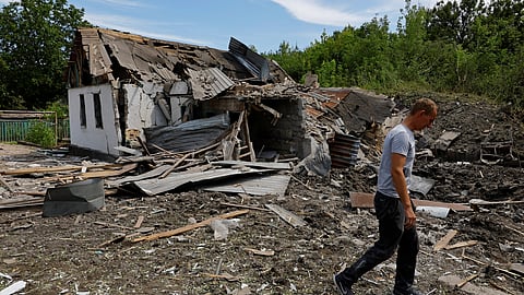 FILE PHOTO: Local resident Sergei Gromenko, 35, walks next destroyed house of his female neighbour who was killed during a shelling in the course of Russia-Ukraine conflict in Donetsk, Russian-controlled Ukraine, July 31, 2023. 