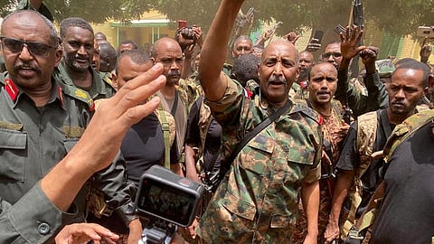 FILE PHOTO: Sudan's General Abdel Fattah al-Burhan stands among troops,in an unknown location, in this picture released on May 30, 2023. 
