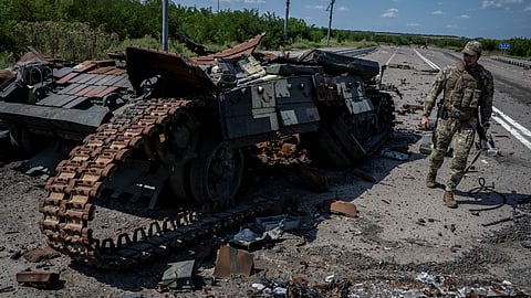 A Ukrainian serviceman walks near a destroyed Ukrainian tank, as Russia's attack on Ukraine continues, near the village of Robotyne, Zaporizhzhia region, Ukraine August 25, 2023. 