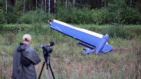 A cameraman films wreckage of the private jet linked to Wagner mercenary chief Yevgeny Prigozhin near the crash site in the Tver region, Russia, August 24, 2023. 