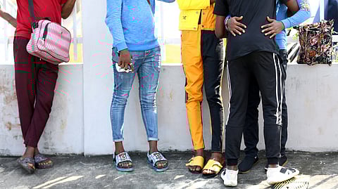FILE PHOTO: Some of the men charged with public displays of affection with members of the same sex are seen gathered outside a court in Lagos, Nigeria October 27, 2020. 