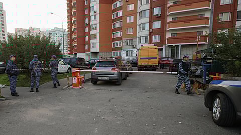 Law enforcement officers secure an area near a multi-storey apartment building, following a reported drone attack in Krasnogorsk, Russia, August 22, 2023. 