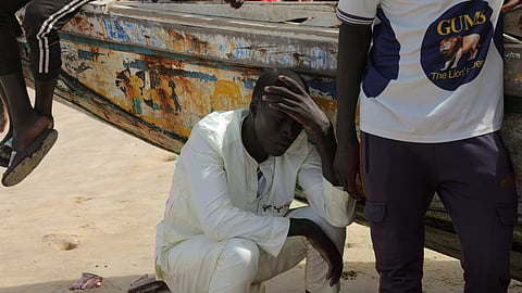 A villager mourns friends and relatives after a boat, lost at sea since last month and carrying local residents, was found in Cape Verde with about 38 survivors out of more than 100 people who boarded it, in Fass Boye, Senegal August 18, 2023. 
