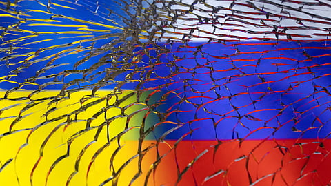 Ukraine and Russian flags are seen through broken glass in this illustration taken March 1, 2022. 