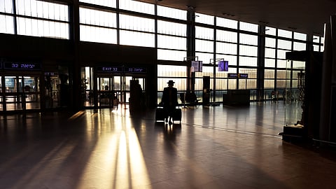 FILE PHOTO: A passenger arrives to a terminal at Ben Gurion international airport in Lod near Tel Aviv, Israel January 25, 2021. 