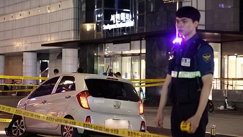 A policeman stands next to a scene where, according to media reports, nine people have been stabbed and four others hurt by a car driven by the suspected attacker in Seongnam, South Korea, August 3, 2023. 