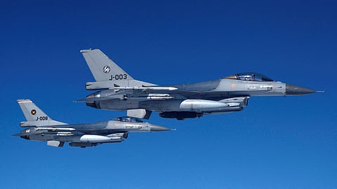 FILE PHOTO: Netherlands' Air Force F-16 fighter jets fly alongside an aircraft simulating aerial interceptions during a media day illustrating how NATO Air Policing safeguards the Allies' airspace in the northern and northeastern region of the Alliance, July 4, 2023. 