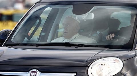 Pope Francis sits in a car ahead of his visit to Portugal for World Youth Day 2023 at Fiumicino airport in Rome, Italy, August 2, 2023. 