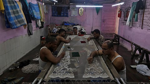 Artisans embroider a cloth inside a workshop in Dharavi, one of Asia's largest slums, in Mumbai, India, August 1, 2023. 