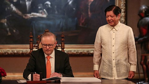 Australia's Prime Minister Anthony Albanese signs the guest book next to Philippine President Ferdinand Marcos Jr. at the Malacanang Presidential Palace in Manila, Philippines, September 8, 2023. 
