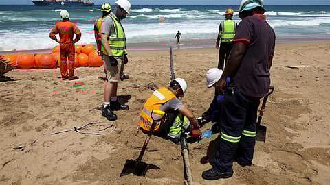 Workers install the 2Africa undersea cable on the beach in Amanzimtoti, South Africa, February 7, 2023. REUTERS/Rogan Ward/File Photo