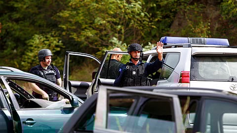 Police officers keep guard in the aftermath of a shooting, near the village of Zvecan, Kosovo September 24, 2023. 