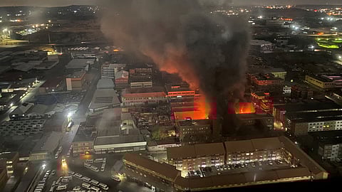 FILE PHOTO: Smoke rises from a burning building amid a deadly fire, in Johannesburg, South Africa, August 31, 2023, in this image obtained from social media. 