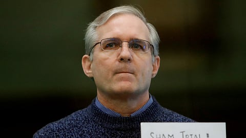 FILE PHOTO: Former U.S. Marine Paul Whelan, who was detained and accused of espionage, stands inside a defendants' cage during his verdict hearing in Moscow, Russia June 15, 2020. 