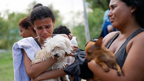 Asylum seekers react as they say goodbye to their pets before leaving them with Mexican families, promising to return for them, before crossing the Rio Grande river to the U.S. border, in Piedras Negras, Mexico September 26, 2023. 