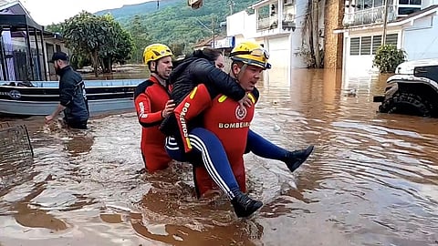 Rescuers carry a person after an extratropical cyclone hit southern cities, in Mucum, Rio Grande do Sul state, Brazil in this screen grab taken from a video released on September 6, 2023. 
