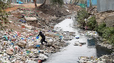 A child collects recyclable material from the Ngong river in Mukuru slums within the Industrial area district, in Nairobi, Kenya September 4, 2023. 