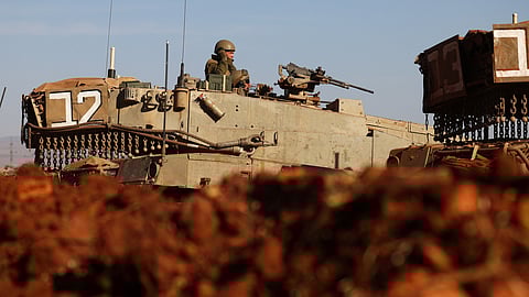 An Israeli soldier is seen in a tank during a military drill near Israel's border with Lebanon in northern Israel, October 26, 2023. 