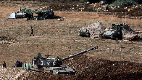 A view shows an Israeli tank and military vehicles near Israel's border with Lebanon, northern Israel, October 9, 2023. 