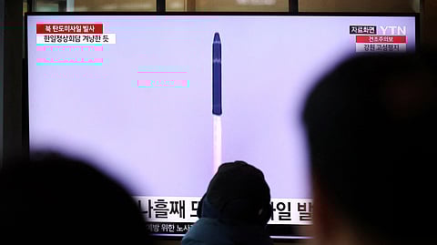 People watch a TV broadcasting a news report on North Korea firing a ballistic missile into the sea off its east coast, at a railway station in Seoul, South Korea, March 16, 2023. 