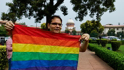 A writer and member of the lesbian, gay, bisexual and transgender community (LGBT community) holds the pride flag while waiting to hear the judgement on same-sex marriage by the Supreme Court in New Delhi, India, October 17, 2023. 
