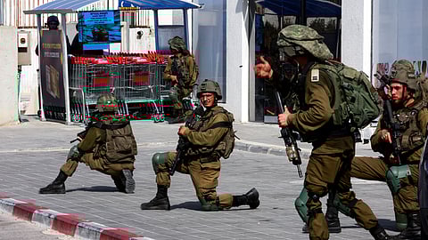 Israeli soldiers work to secure residential areas following a mass-infiltration by Hamas gunmen from the Gaza Strip, in Sderot, southern Israel October 7, 2023. 