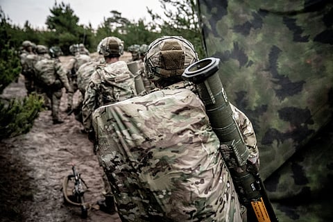 FILE PHOTO: Soldiers from the Schleswig Infantry Regiment on drill at the Oksboel Shooting and Training Ground, Jutland, Denmark, March 16, 2023. The regiment is one of four combat troop regiments under the Danish Army Command. 