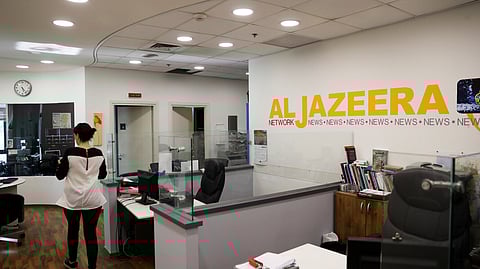 FILE PHOTO: An employee walks inside an office of Qatar-based Al-Jazeera network in Jerusalem June 13, 2017. Picture taken June 13, 2017. 